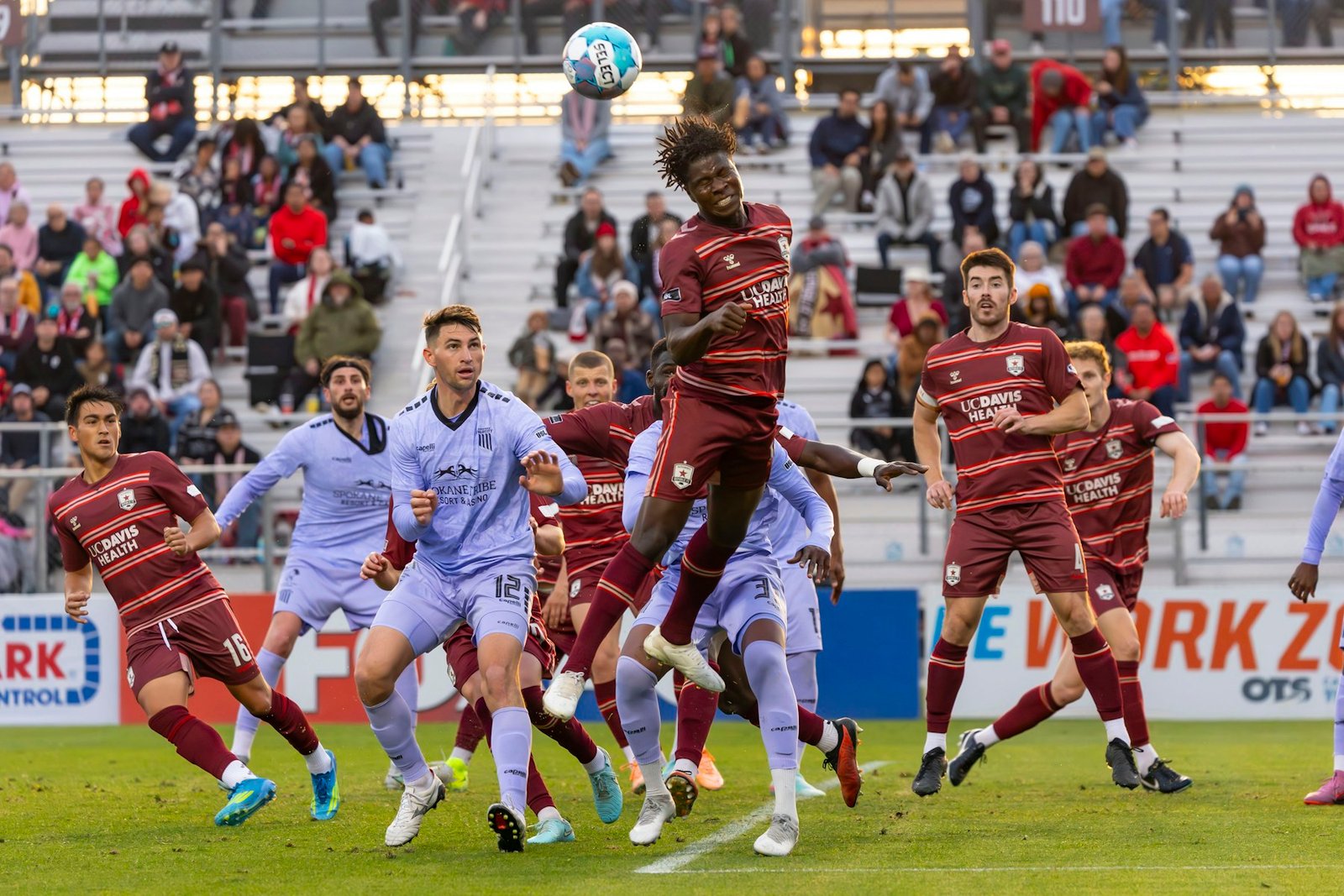 Adult players competing for the ball during a match